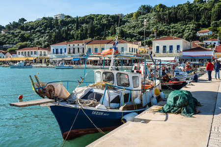 Katakolo, Greece - November 11, 2019: Wooden fishing boats moored in harbor of the Katakolo (Olimpia), Greece. Fishing nets on the shore.のeditorial素材