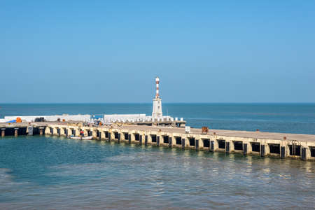 Mormugao, Goa, India - November 23, 2019: View on the Mormugao Breakwater lighthouse and pier in South Goa, Goa state, India.のeditorial素材