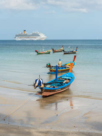 Phuket, Thailand - November 29, 2019: Selective focus on the traditional longtail boat on the Patong beach at Andaman sea, Phuket island in Thailand. The Patong Bay - Cruise Docking Phuket.のeditorial素材