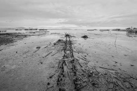 View of remains of the old pier at low tide, Tan Jetty, George Town, Penang, Malaysia. Black and white photography for printing.の写真素材