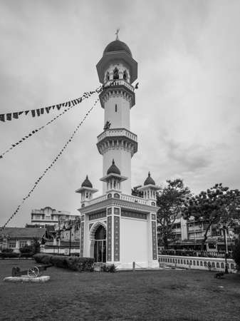 George Town, Penang, Malaysia - December 1, 2019: The minaret of the Kapitan Keling Mosque. It was built in the 19th century by Indian Muslim traders in George Town, Penang, Malaysia. Black and white retro style.のeditorial素材