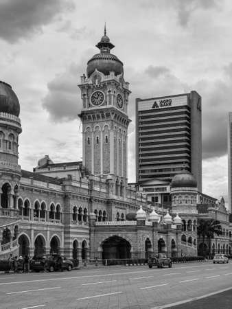 Kuala Lumpur, Malaysia - December 2, 2020: The clock tower of the Sultan Abdul Samad building in front of the Merdeka Square in Jalan Raja, Kuala Lumpur, Malaysia. Black and white photo in retro style.のeditorial素材