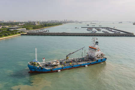 Singapore - December 3, 2019:  Oil Products Tanker Zemira prepares to refuel a cruise ship at Singapore port.のeditorial素材