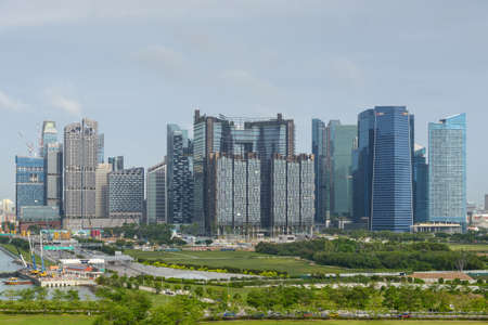 Singapore - December 3, 2019:  Singapore city skyline of business district downtown in daytime. View from the ship at the cruise port.のeditorial素材