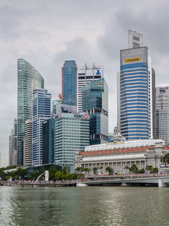 Singapore - December 3, 2019:  Singapore city skyline of business district downtown in cloudy weather. The Fullerton Hotel in the center.のeditorial素材