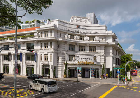 Singapore - December 4, 2019: The white building with corner entrance to the Capitol Kempinski Hotel at the Downtown Core in Singapore.のeditorial素材