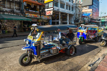 Bangkok, Thailand - December 7, 2019: Famous moto-taxi called tuk-tuk is a landmark of the city and popular transport, Tuk tuk on the street in Bangkok, Thailand.のeditorial素材