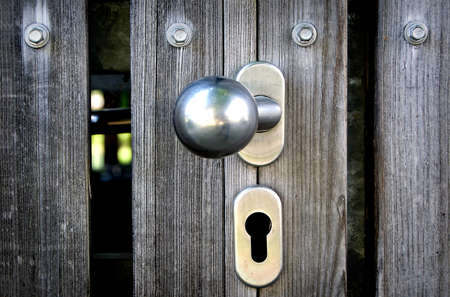 Photo door lock and handle in a wooden doorの写真素材