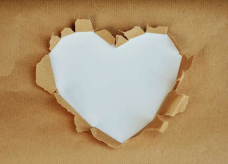 Photo which shows a white heart on paper backgroundの写真素材