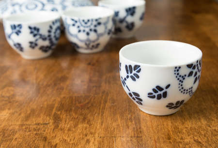 A closeup of a teacup set on a wooden tableの写真素材