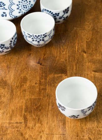 A closeup of a teacup set on a wooden tableの写真素材