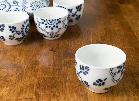 A closeup of a teacup set on a wooden tableの写真素材