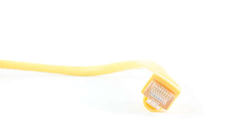 A yellow ethernet cable against a white background.の写真素材