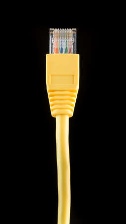 A yellow ethernet cable against a black background.