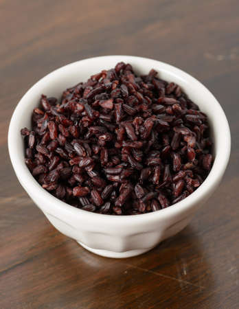 Fresh cooked black rice in a white bowl.の写真素材