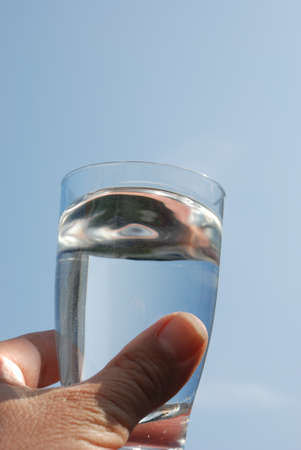 Hand holding glass of water