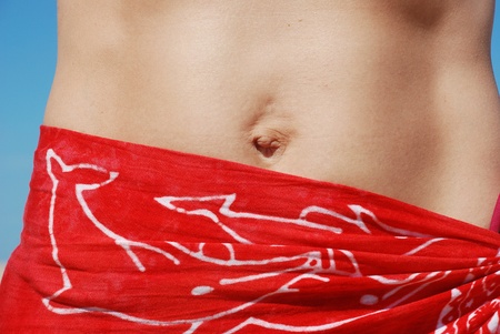 Woman in red pareo on the beachの写真素材