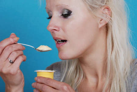 young woman eatin creamの写真素材