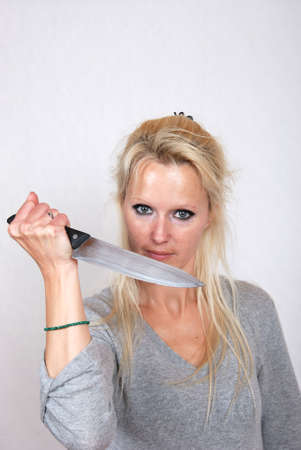 Woman with knifeの写真素材