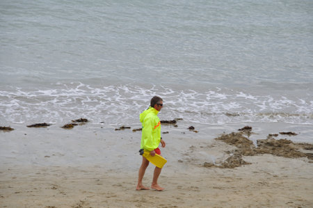 SAINT-QUAY PORTRIEUX FRANCE,24 AUGUST, 2014: Lifeguard keeps watch on the beachのeditorial素材