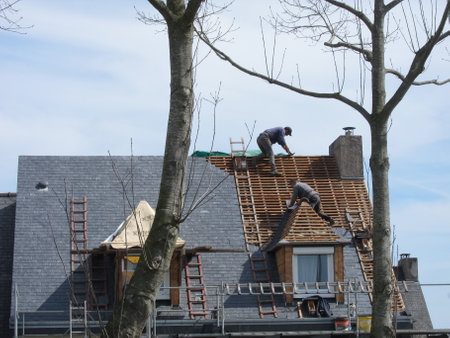 PLERIN, FRANCE 06 APRIL, 2018: Roofing workers on a roof at Plerinのeditorial素材