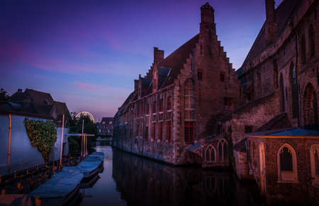 There is a carnaval in Bruges, Belgium, and the ferris wheel stands out against the evening sky.のeditorial素材