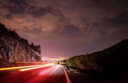A car speeds by towards a city that never sleeps.