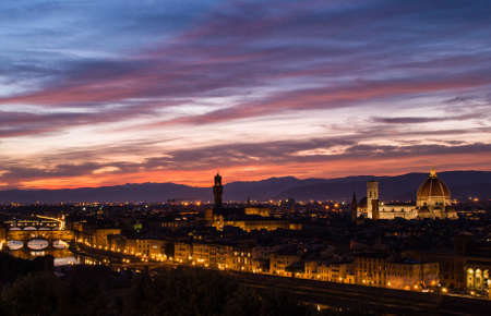A fiery sunset over Firenze, with Il Duomo and the Belffry of Palazzo Vecchioのeditorial素材