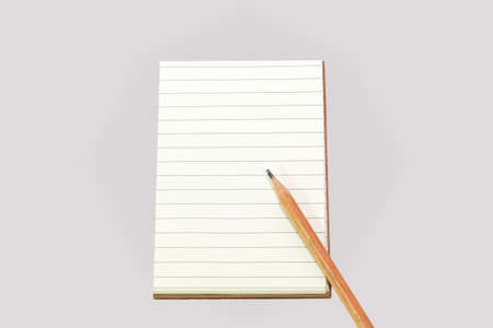empty lines notebook with brown cover and brown pencil ,isolated backgroundの写真素材