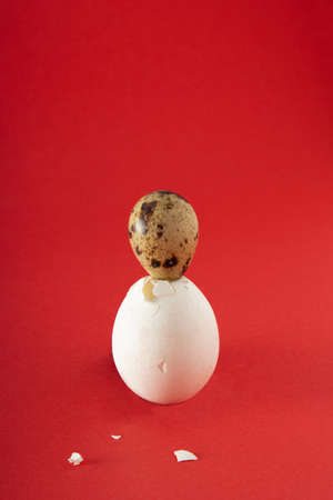 Beating of Easter eggs on red background. Minimal Holiday concept.