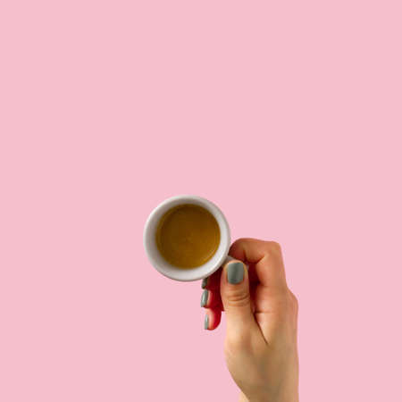 Cup in the hand on the pastel background. Timebreak for coffee. Top view. Flat lay.