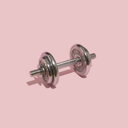 Silver weights on a pastel pink background. Creative minimal concept gym at home. Healthy life on the quarantine.の写真素材