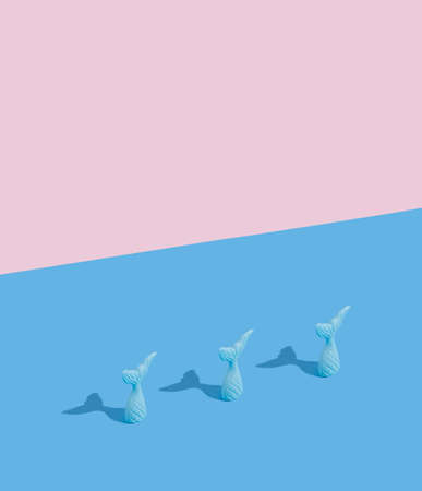 Blue fin on the blue background and copy space on the pastel pink layout. Summer creative minimal...