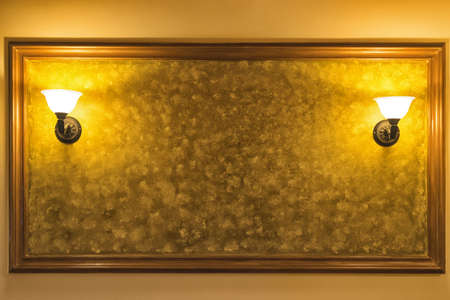 Old vintage lamp on the wall with framed yellow background.の写真素材