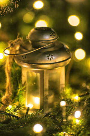 Composition of christmas decorations and candle light with beautiful bokeh on the christmas treeの写真素材