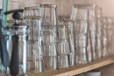 Set of glasses on the wooden shelf, tonedの写真素材