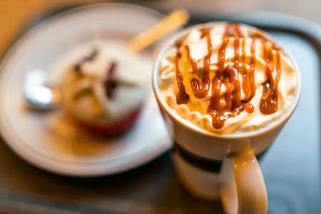 Picture of coffee mug with blurred dessert on the background