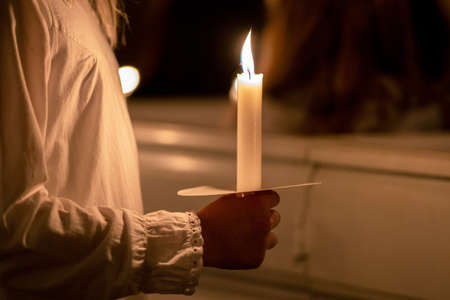 People handling candles in the hands. Christmas and lucia holidaysの写真素材
