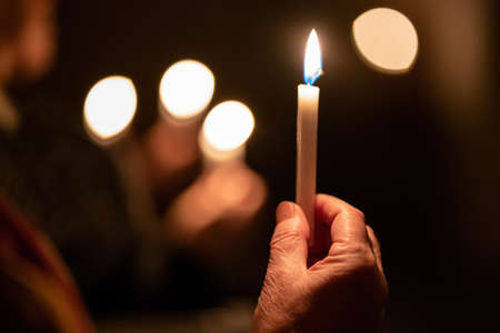 People handling candles in the hands. Christmas and lucia holidays