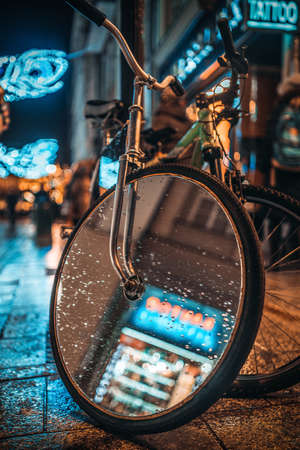 Picture of bicycle with mirror on the wheel at the night street.の写真素材