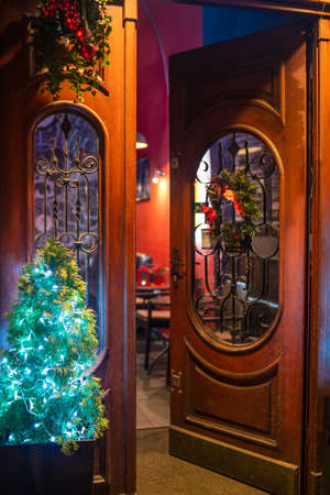 Opened wooden door at christmas time at the streetの写真素材