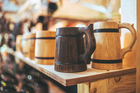Wooden handmade cups in scandinavian style on the christmas street marketの写真素材