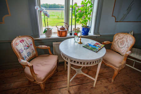 Vaxjo, Seden - October, 2018: Vintage furniture, decor inside classic Bergkvara Tantens cafe, beautifully situated in a cultural environment dating back to the 15th century.のeditorial素材