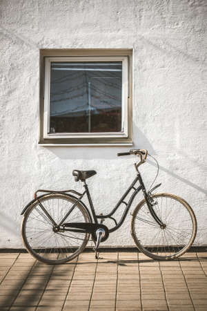 Retro bicycle on roadside with vintage concrete wall backgroundの写真素材