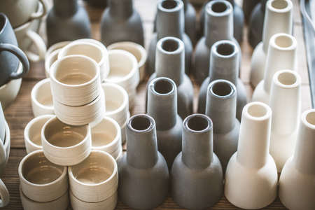 Rustic handmade ceramic clay white cups souvenirs on the Street handicraft market.の写真素材
