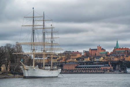 Wonderful autumn scenery of the Old Town with historcal ship at Skeppsholmen island in Stockholm