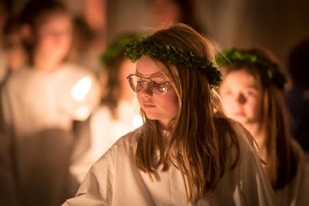Vaxjo, Sweden - December, 2017: The swedish tradition of Lucia is celebrated in Vaxjo church with song, candles and white gowns.のeditorial素材