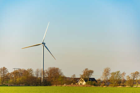 Wind turbines on the beautiful autumn meadow.の写真素材