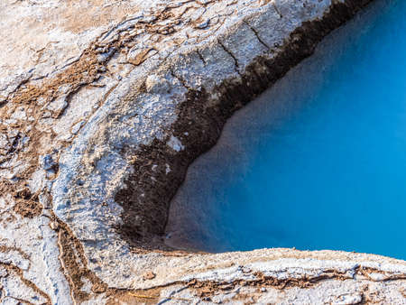 Picture of Blue geothermal pond at The Great Geysir, an active volcanic geyser in Southwestern Icelandの写真素材