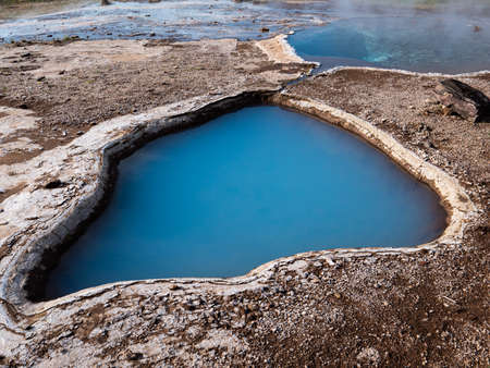 Picture of Blue geothermal pond at The Great Geysir, an active volcanic geyser in Southwestern Icelandの写真素材
